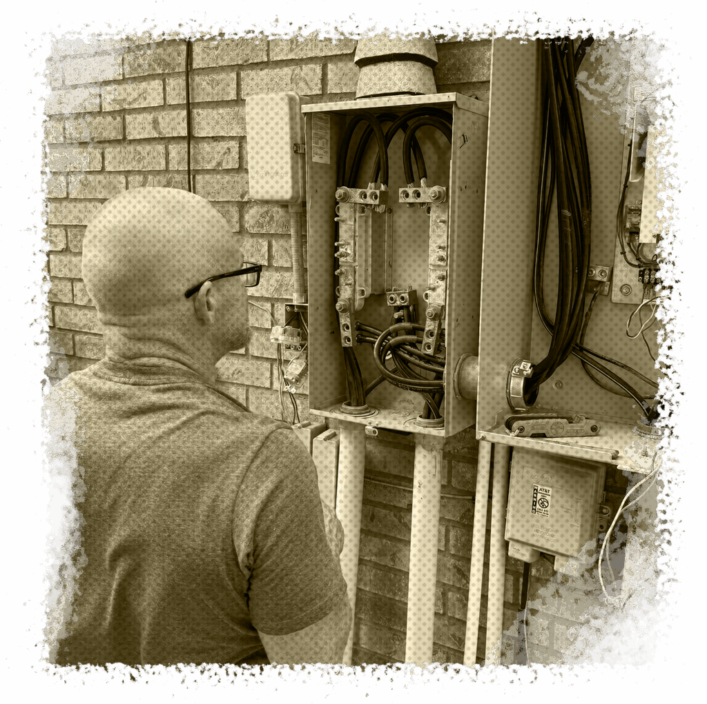 Electrician inspecting electrical panel upgrade, showcasing safety and efficiency in home electrical systems, All Star A/C, Plumbing & Electrical, Houston, TX.