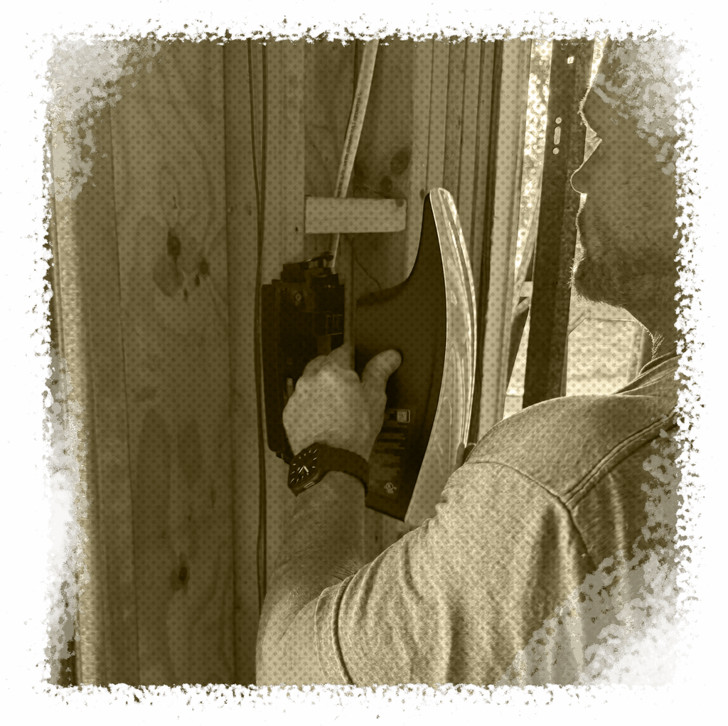 Electrician installing electrical components on wooden framing, emphasizing professional service for EV charger installation in Houston, TX.