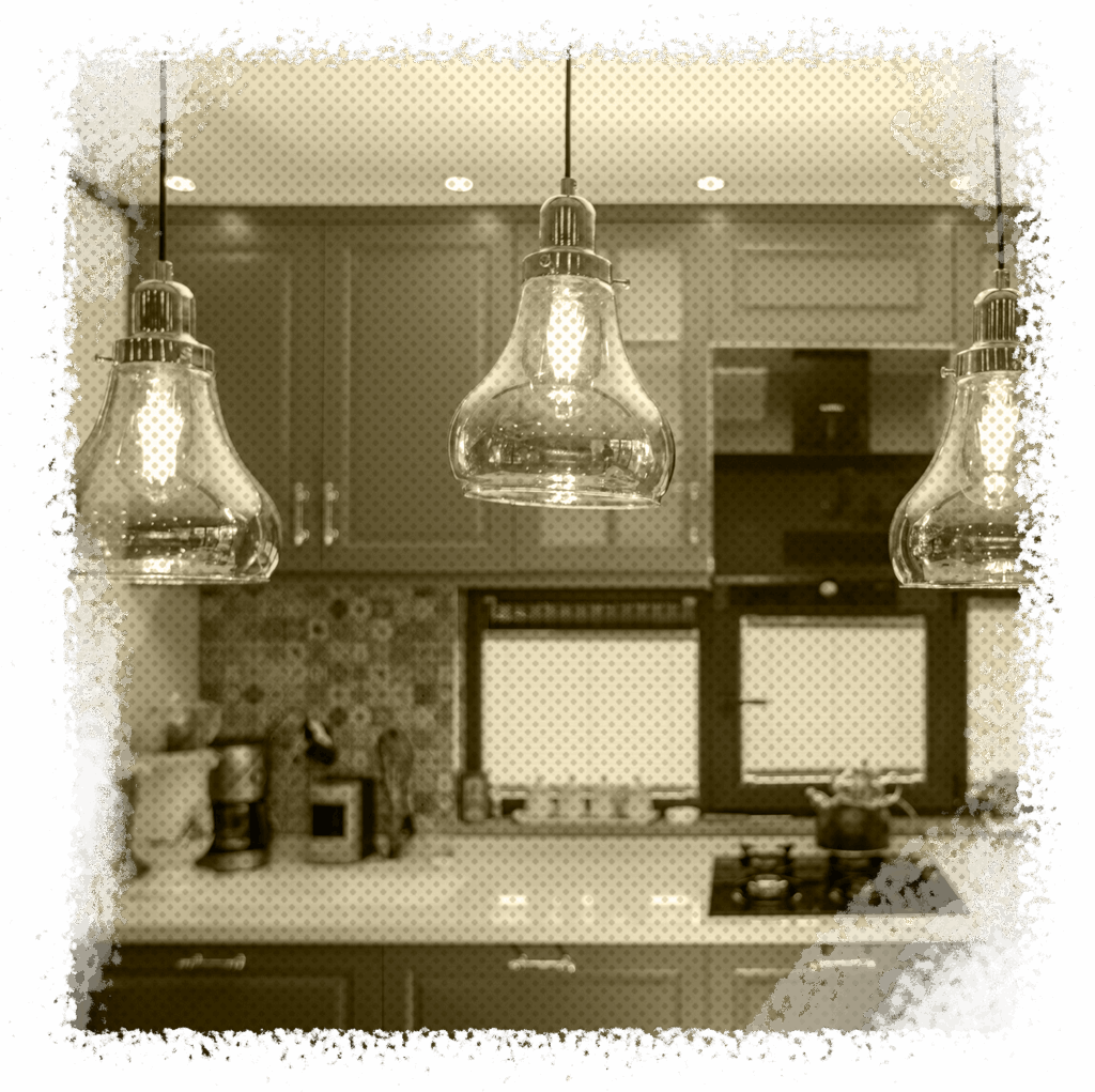 Kitchen interior featuring stylish pendant lighting and cabinetry, highlighting professional lighting installation services by All Star A/C, Plumbing & Electrical in Houston, TX.