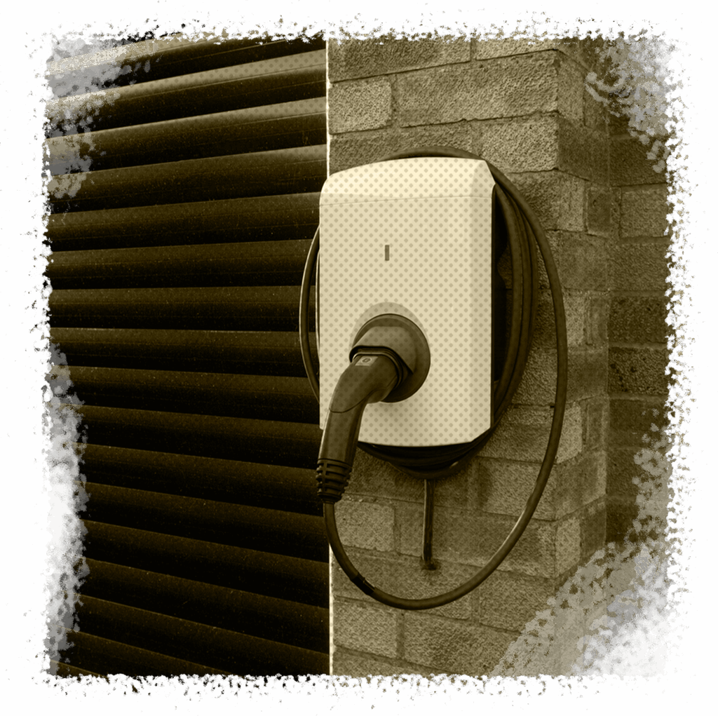 Electric vehicle charger mounted on a brick wall, showcasing installation services by All Star A/C, Plumbing & Electrical in Houston, TX.