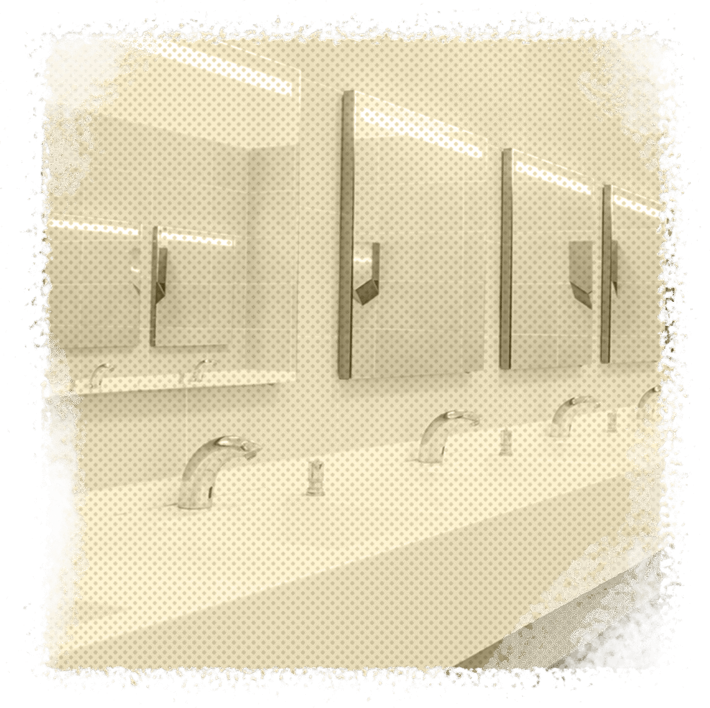 Commercial restroom sinks with modern faucets and mirrors, emphasizing plumbing solutions for businesses in Houston, TX.